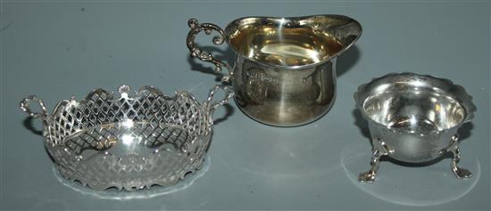 Dutch silver pierced basket, a cream jug and a salt (3)